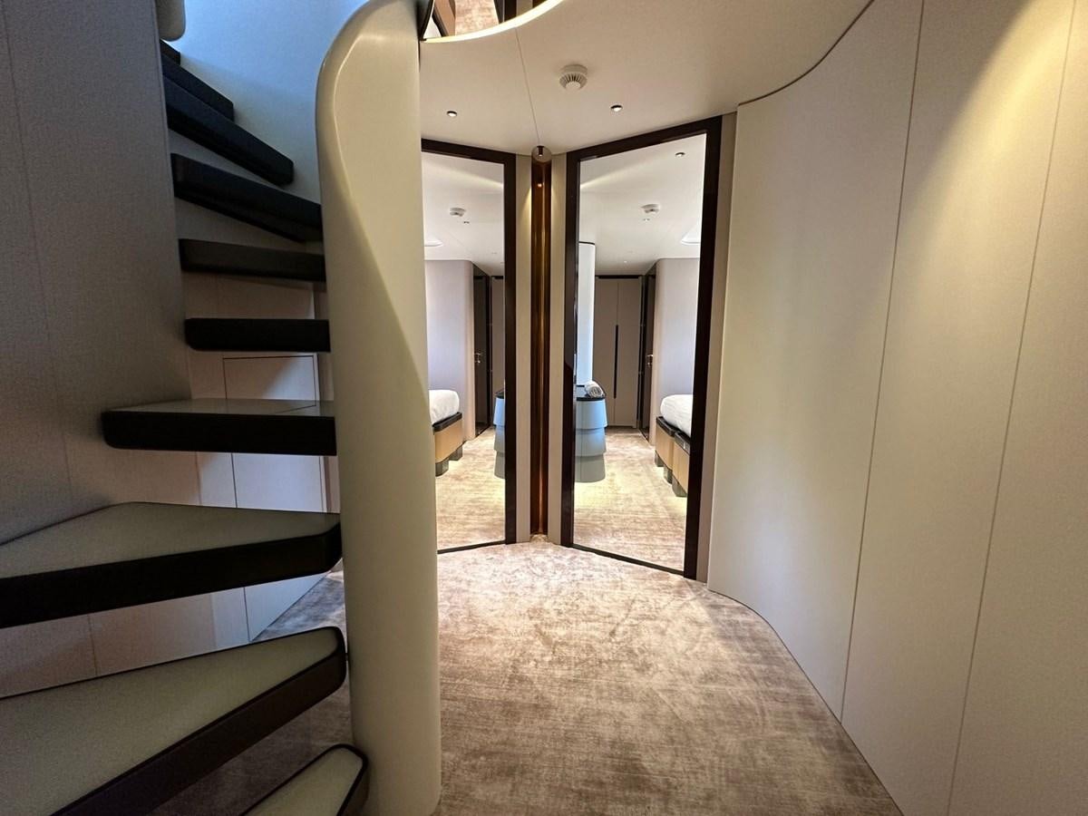 a hallway with a door and a carpet aboard NG Yacht for Sale