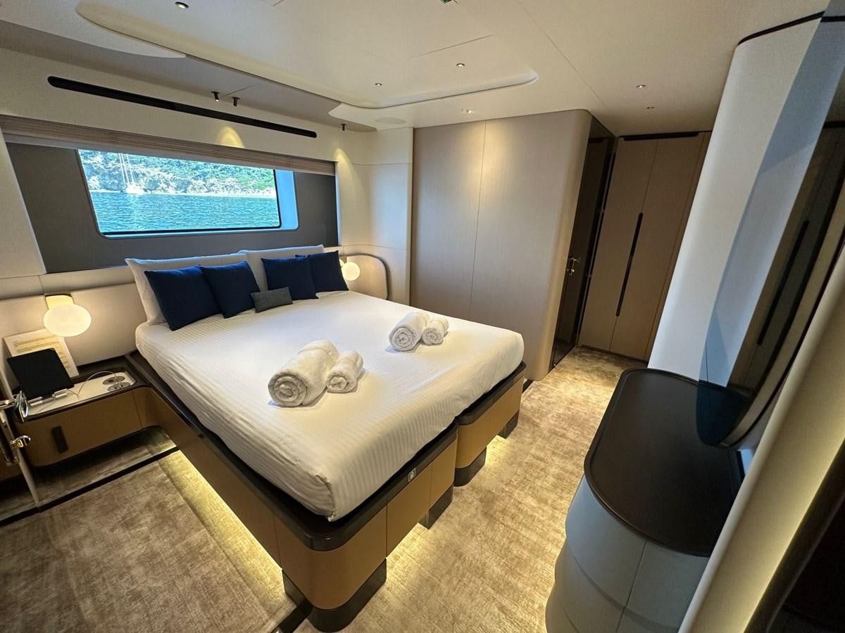 a room with a bed and a window aboard NG Yacht for Sale