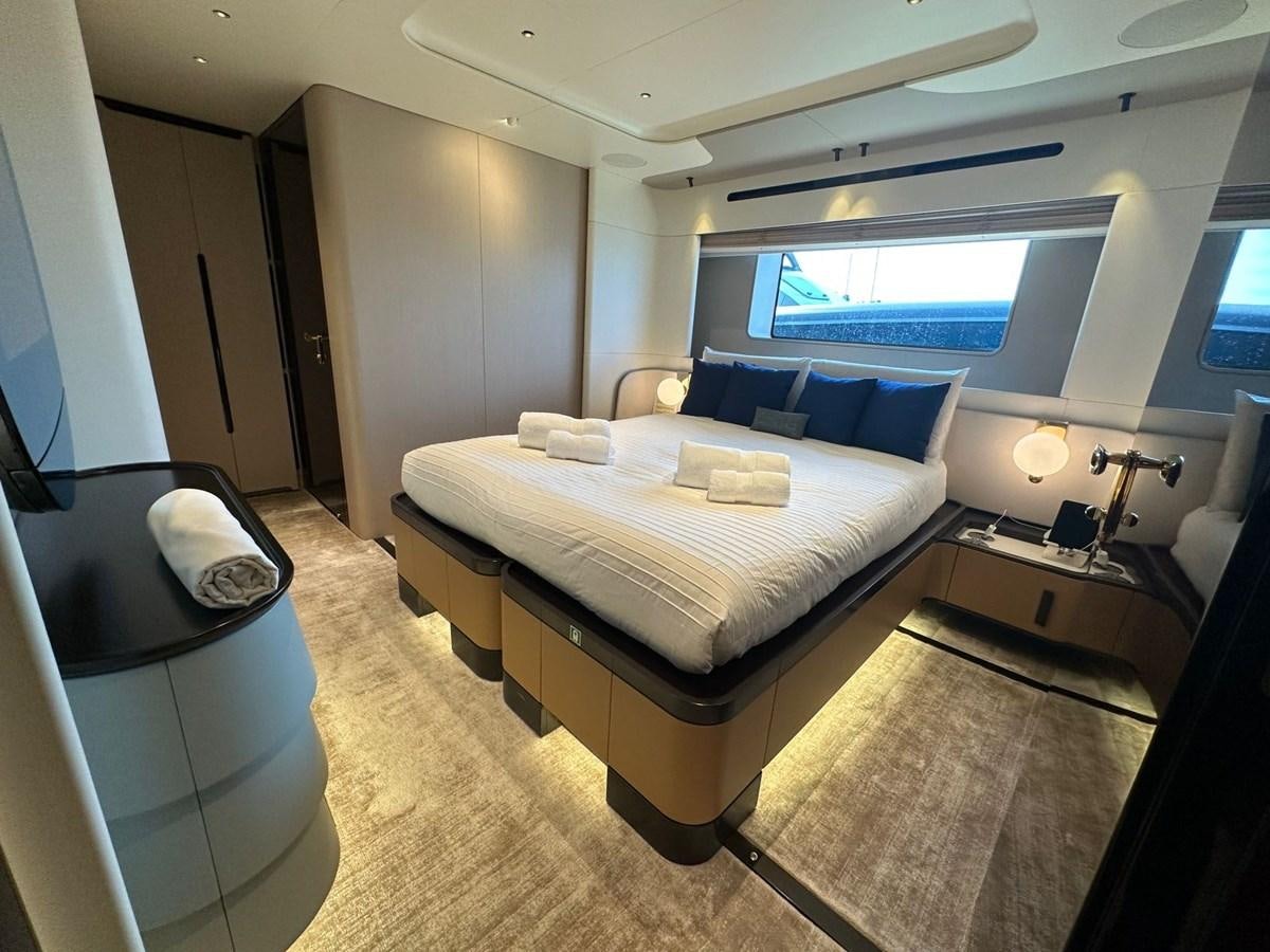 a room with a bed and a window aboard NG Yacht for Sale