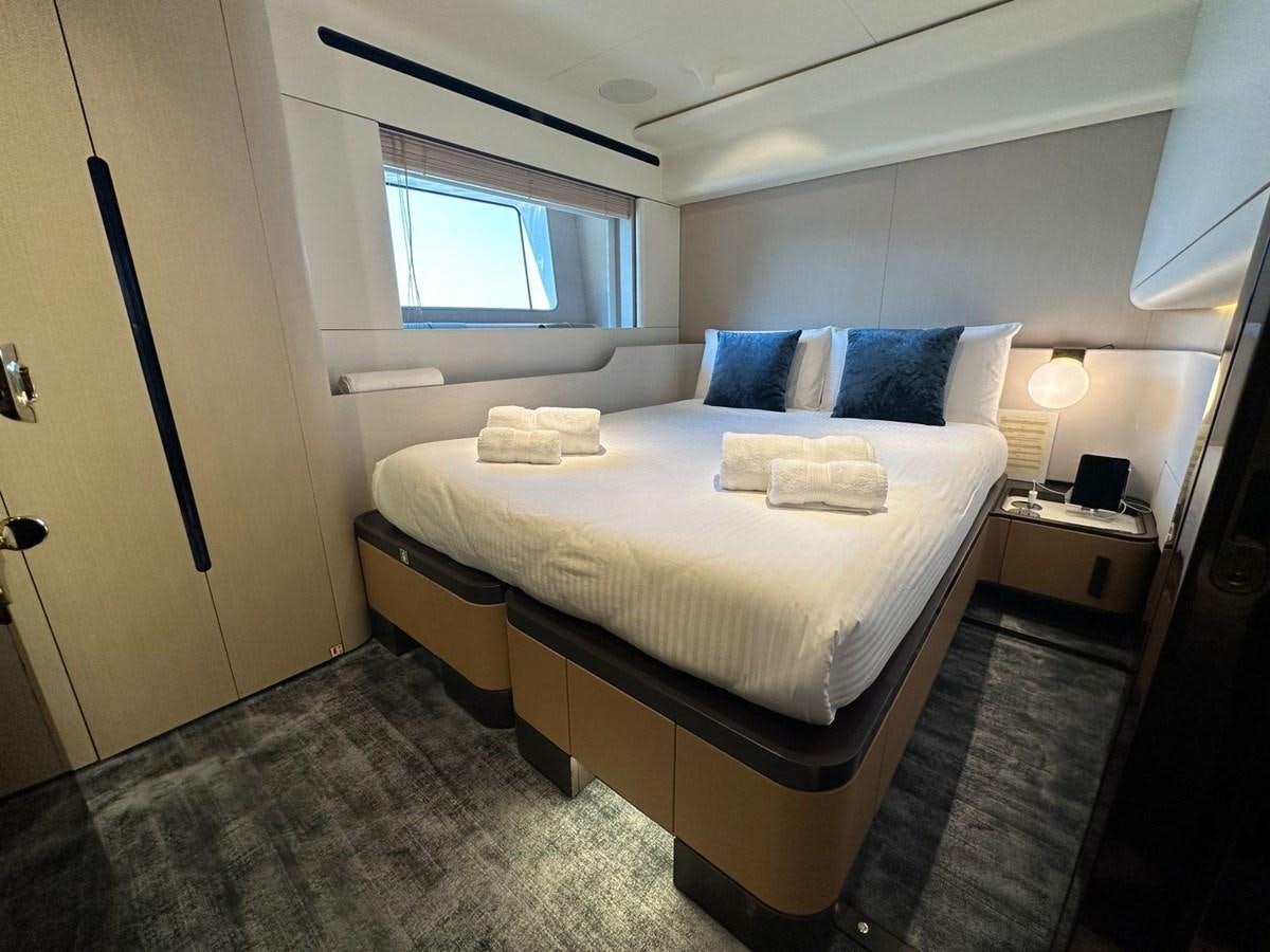 a bed with a white sheet aboard NG Yacht for Sale