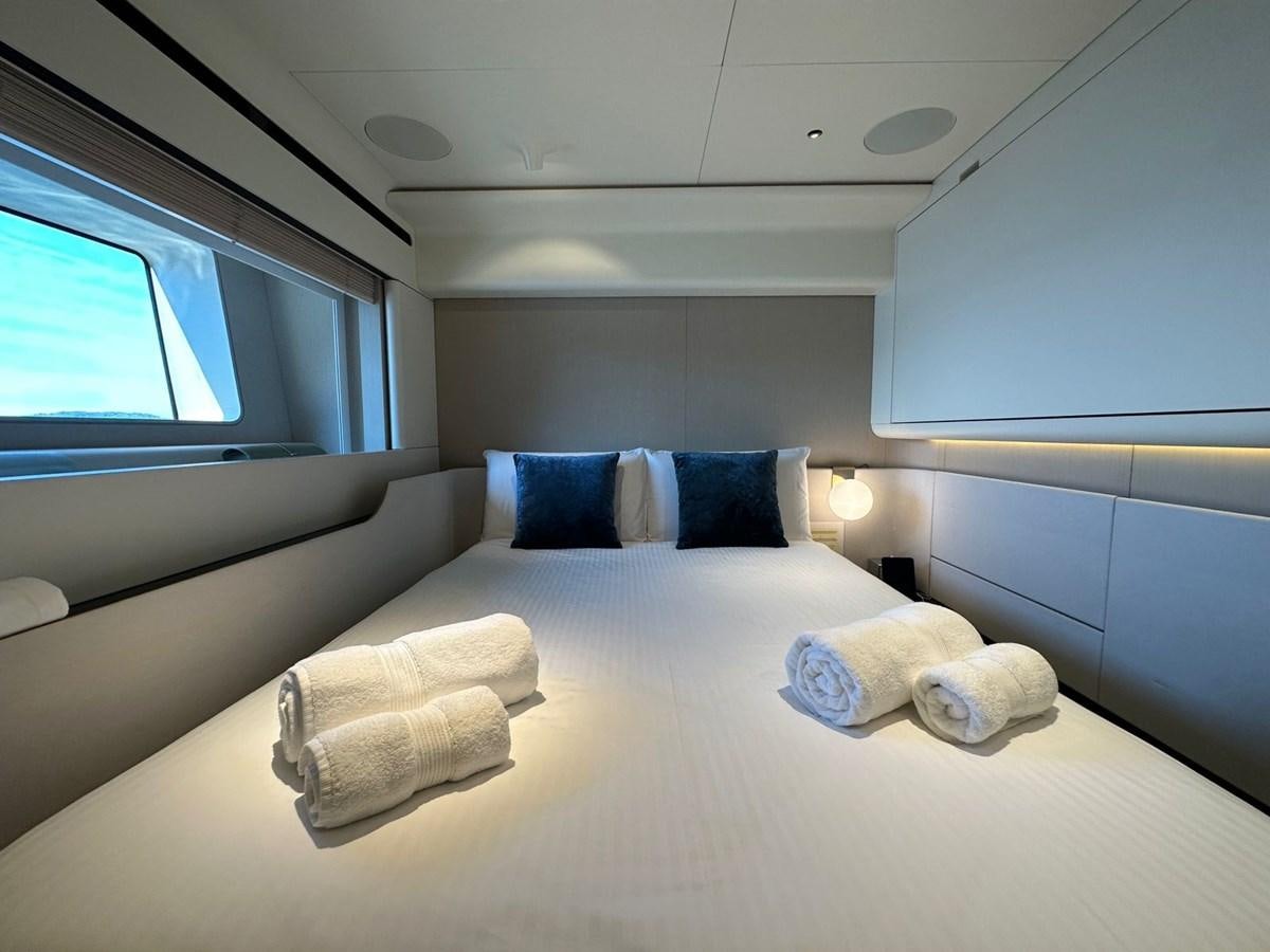 a bed with pillows aboard NG Yacht for Sale