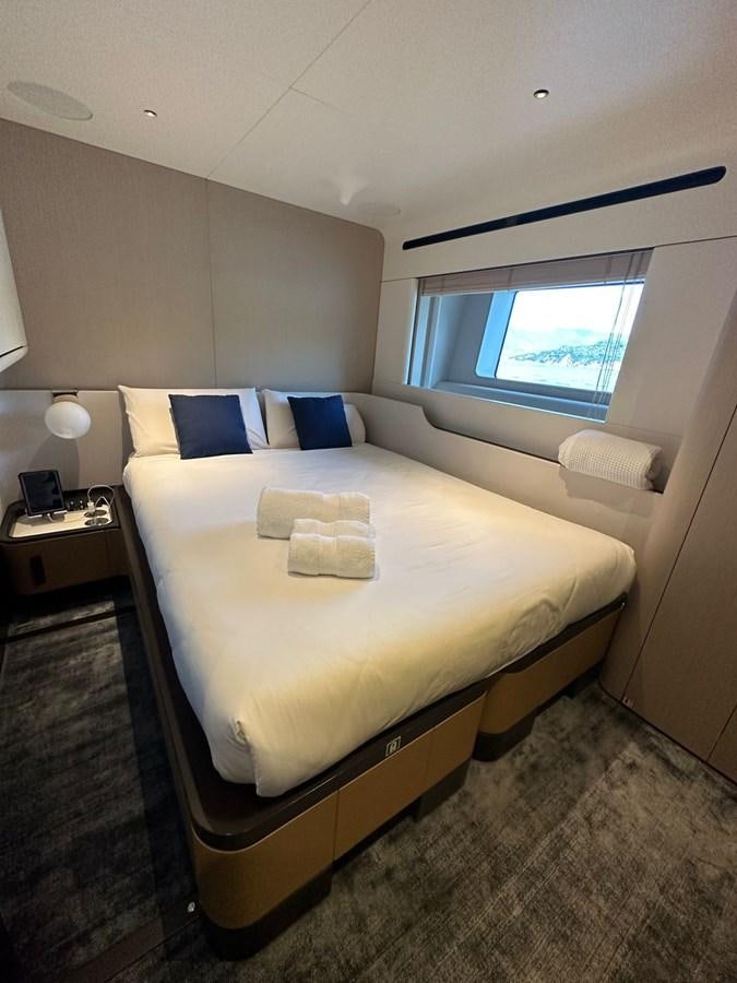 a bed with a white sheet and pillows aboard NG Yacht for Sale