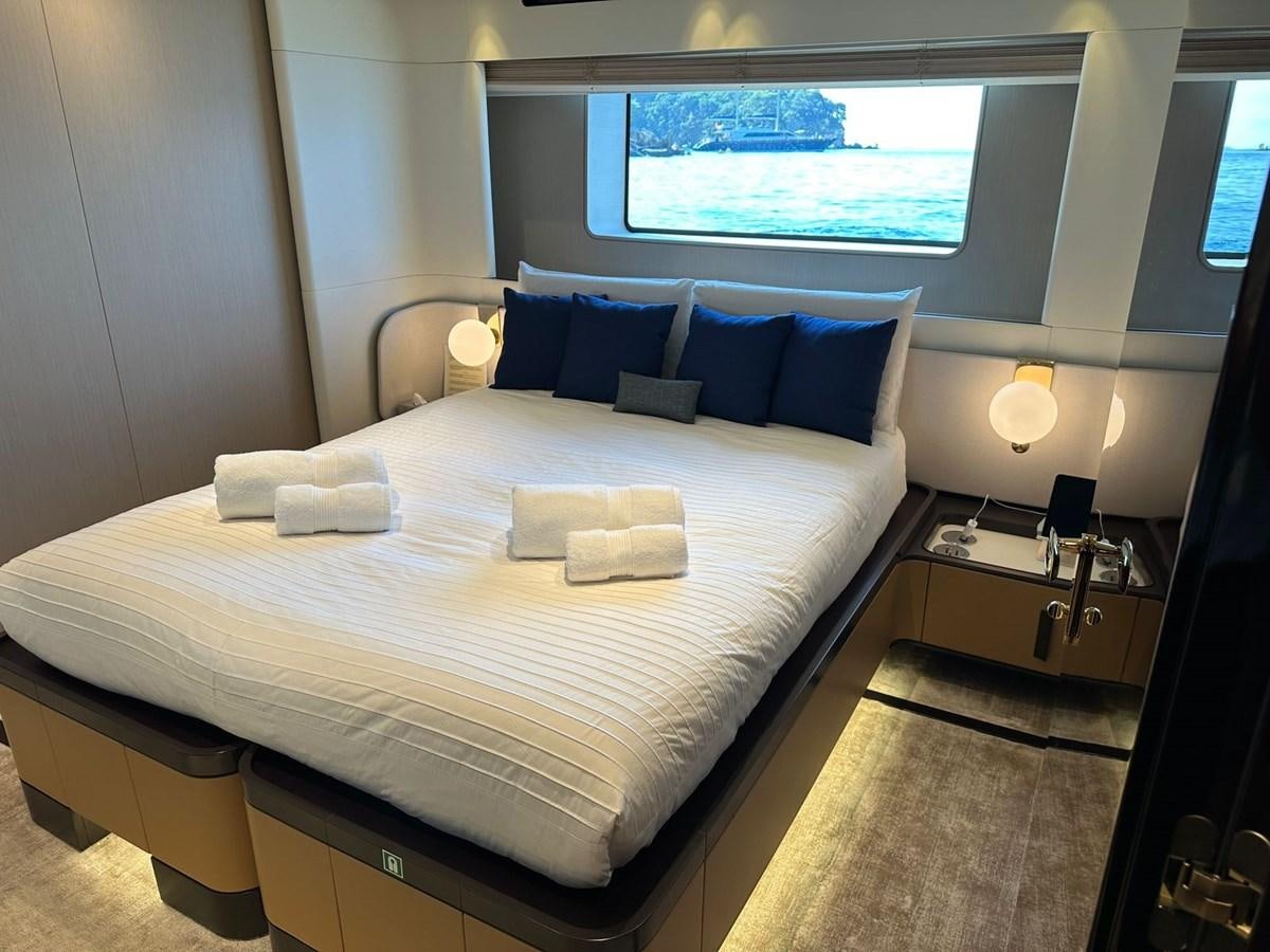 a bed with a white bed spread aboard NG Yacht for Sale