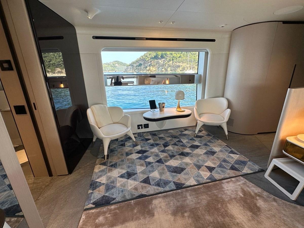a room with a table chairs and a large window aboard NG Yacht for Sale
