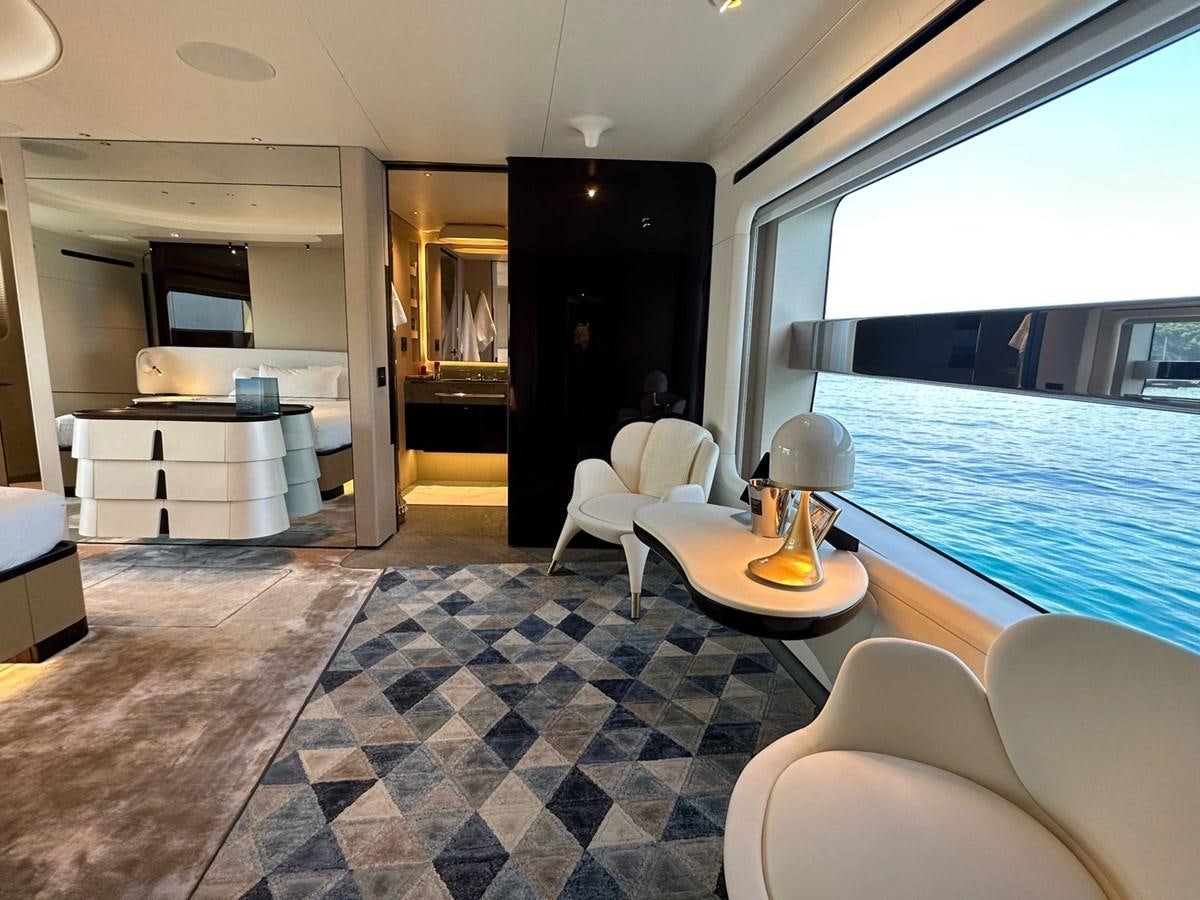 a room with a table chairs and a bed aboard NG Yacht for Sale