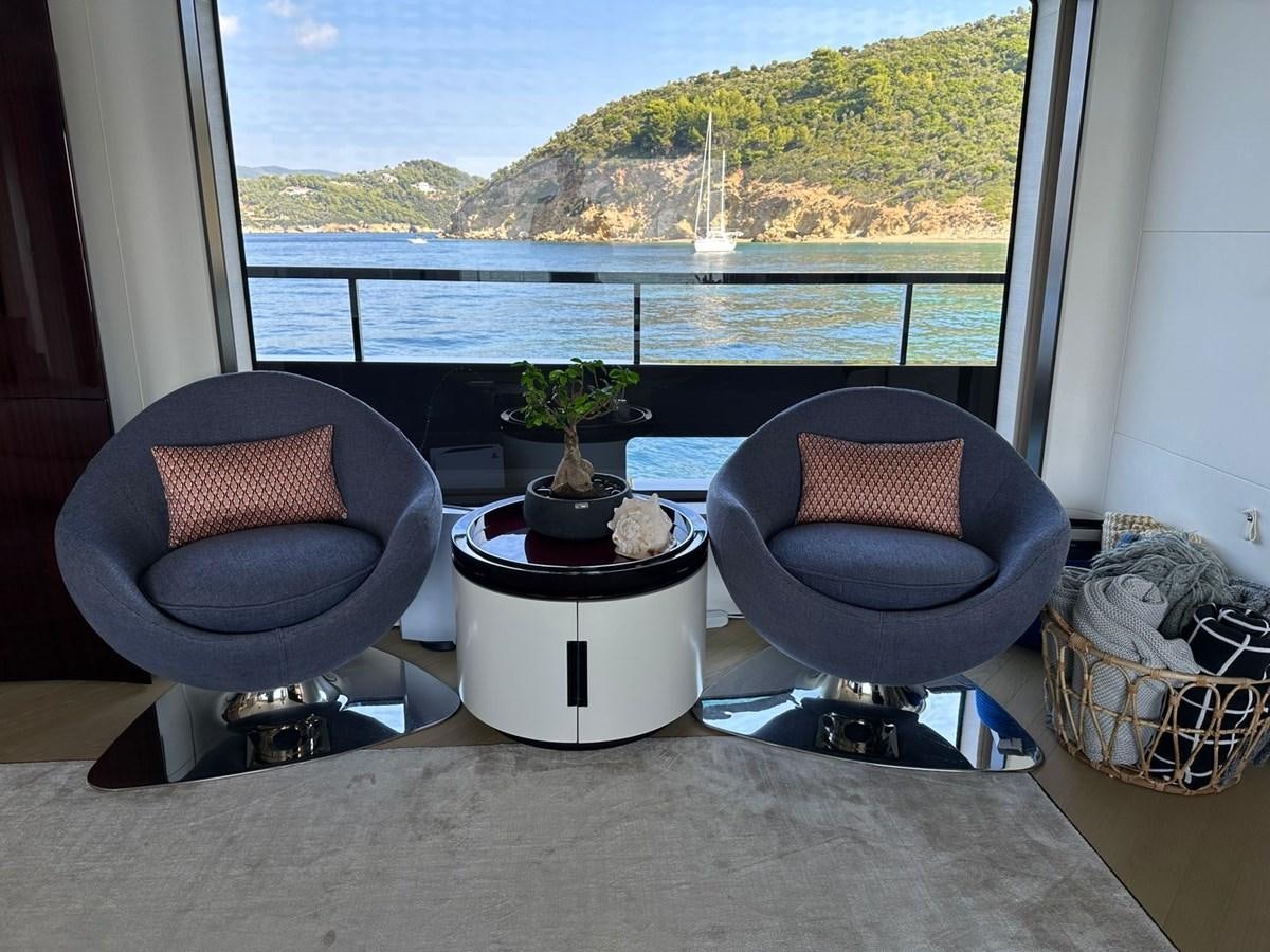 a room with a table and chairs aboard NG Yacht for Sale