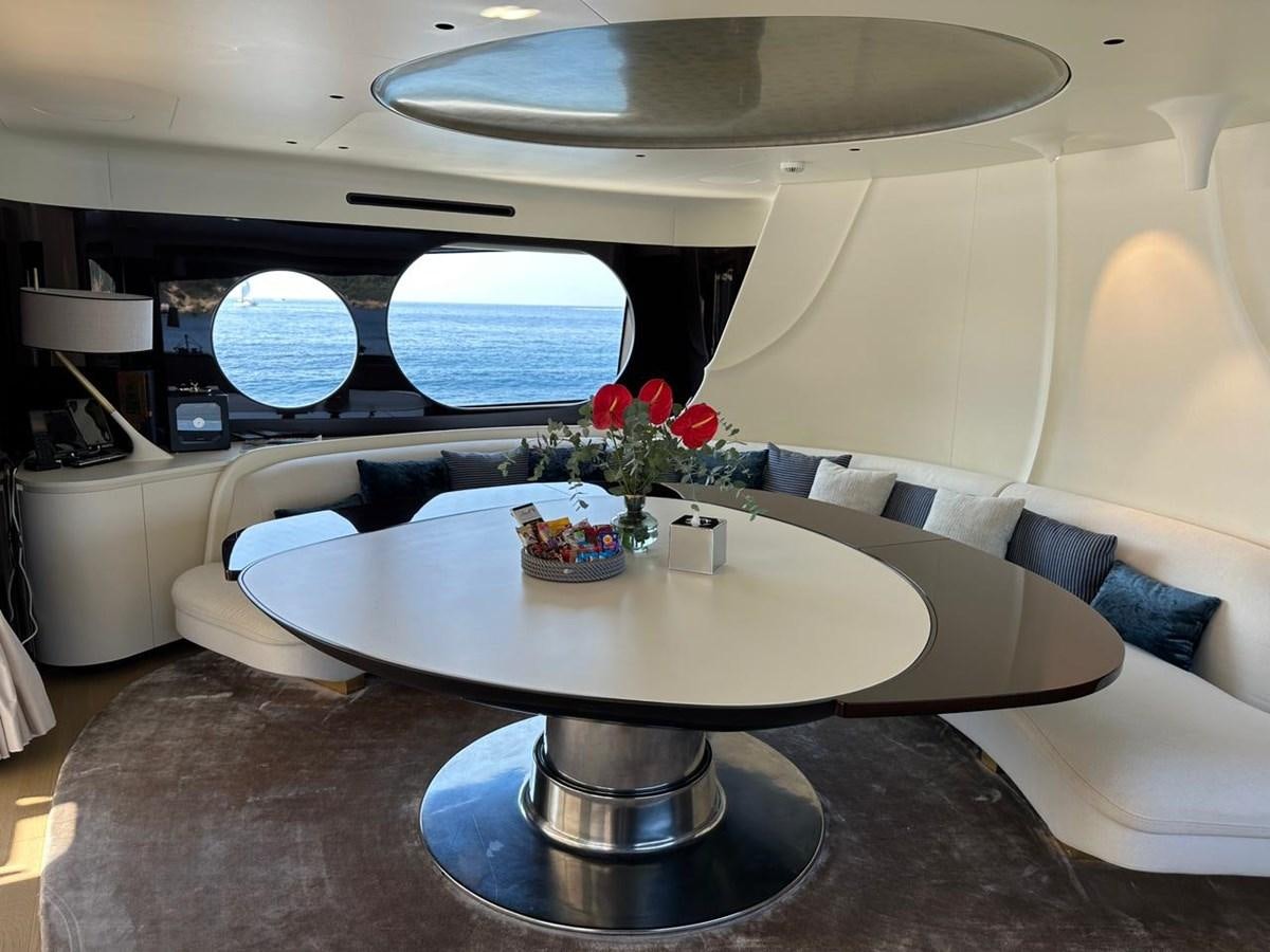 a room with a table and chairs aboard NG Yacht for Sale