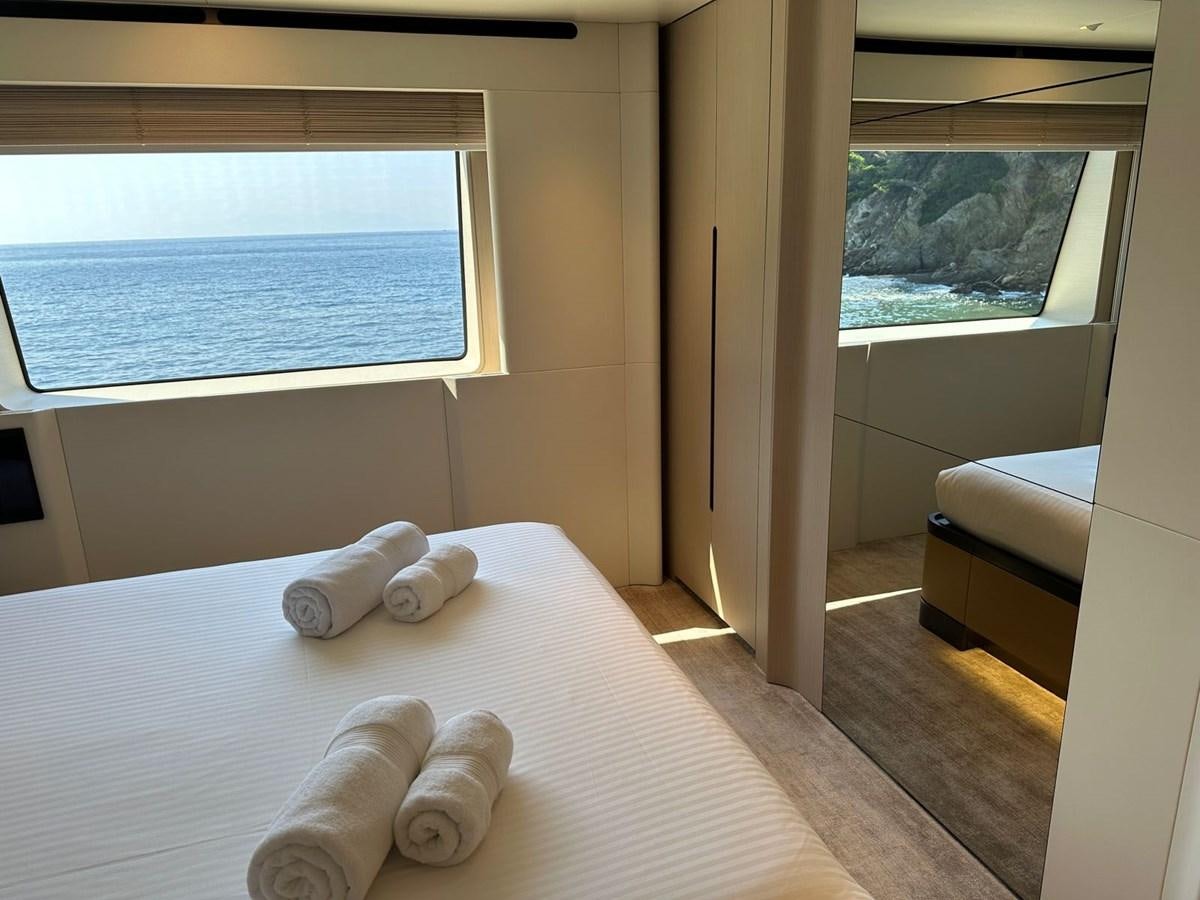 a bed with white sheets aboard NG Yacht for Sale