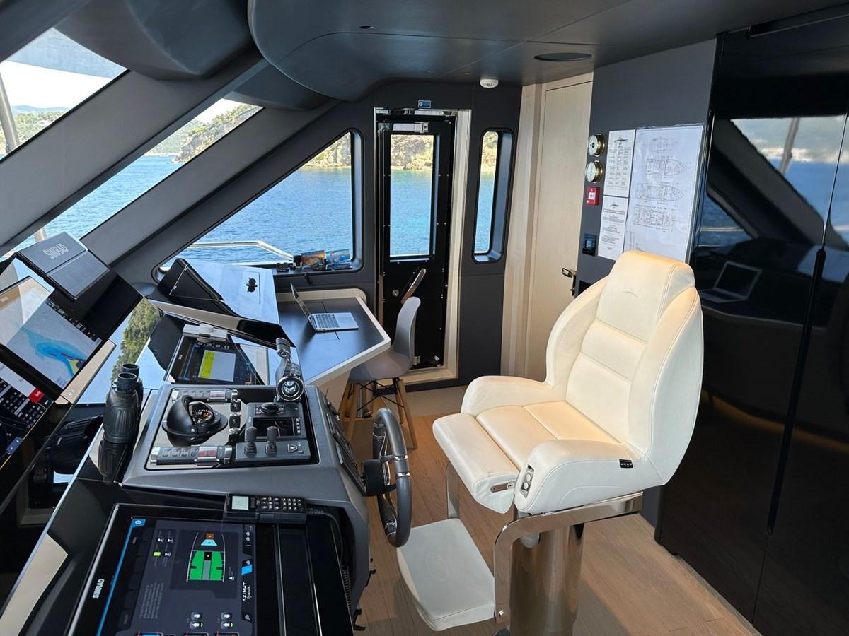 a room with a desk and chairs aboard NG Yacht for Sale