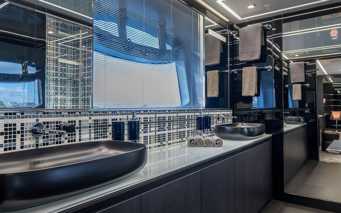 a bathroom with a sink and a large mirror aboard ALDEBARAN III Yacht for Sale
