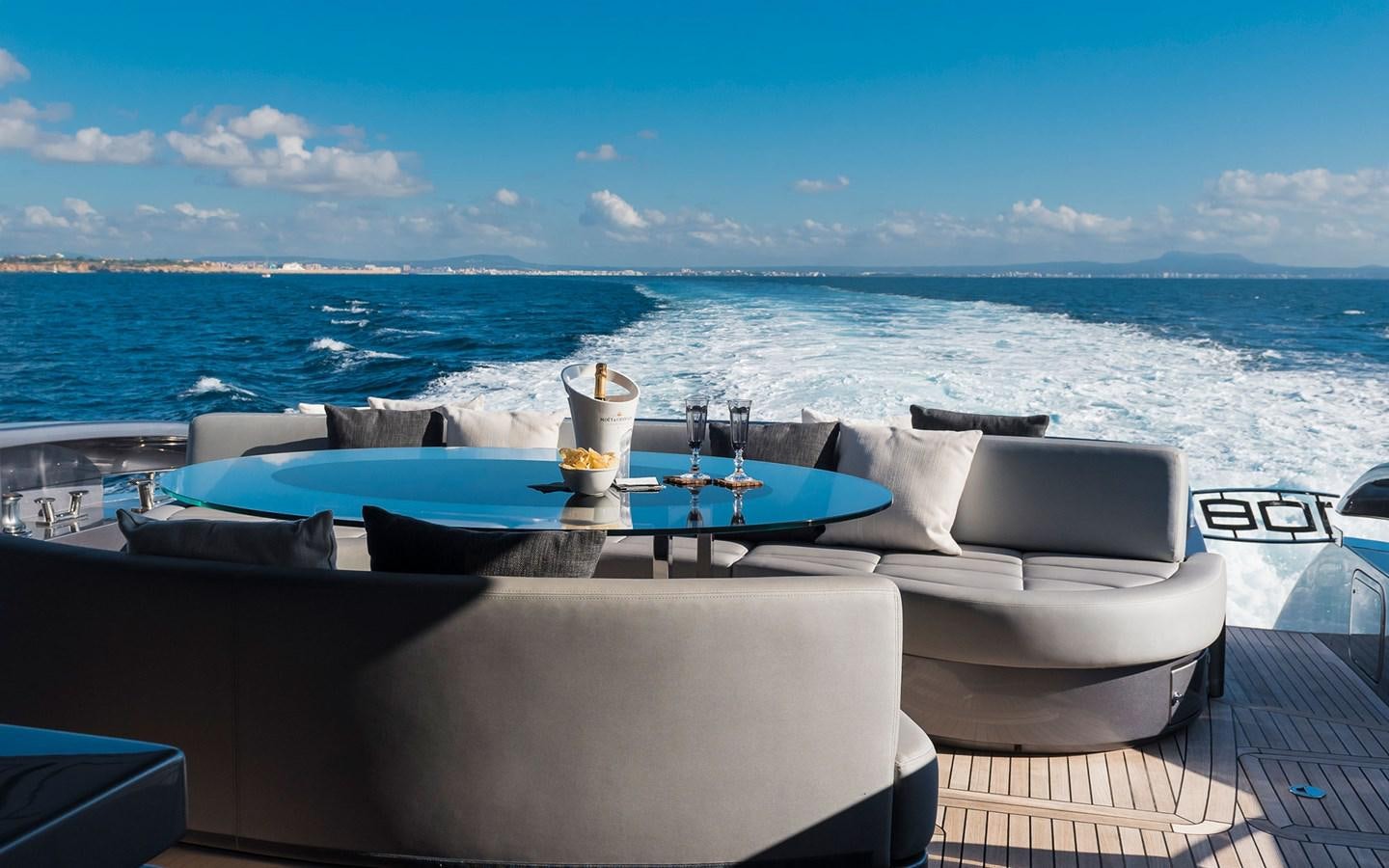 a large white boat with a glass of wine on the deck aboard ALDEBARAN III Yacht for Sale