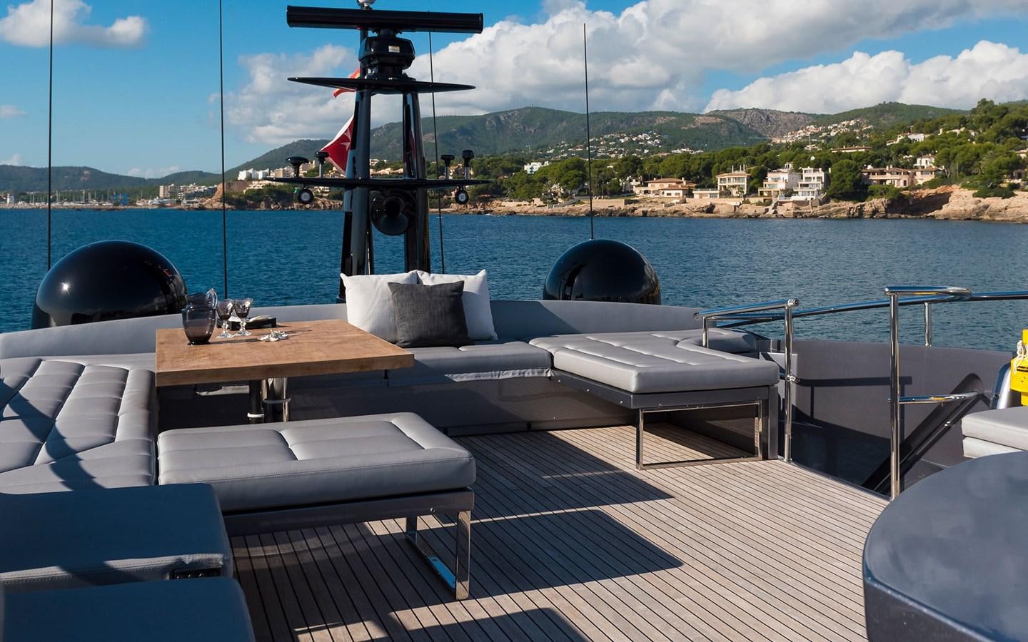 a deck with chairs and a table on it aboard ALDEBARAN III Yacht for Sale