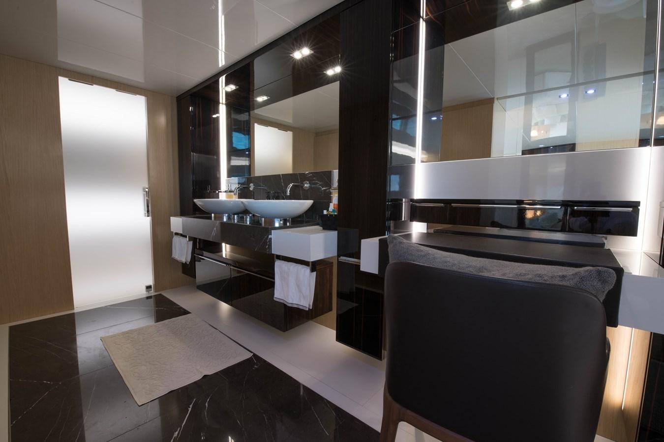 a modern kitchen with a large mirror aboard NIGHT FURY Yacht for Sale