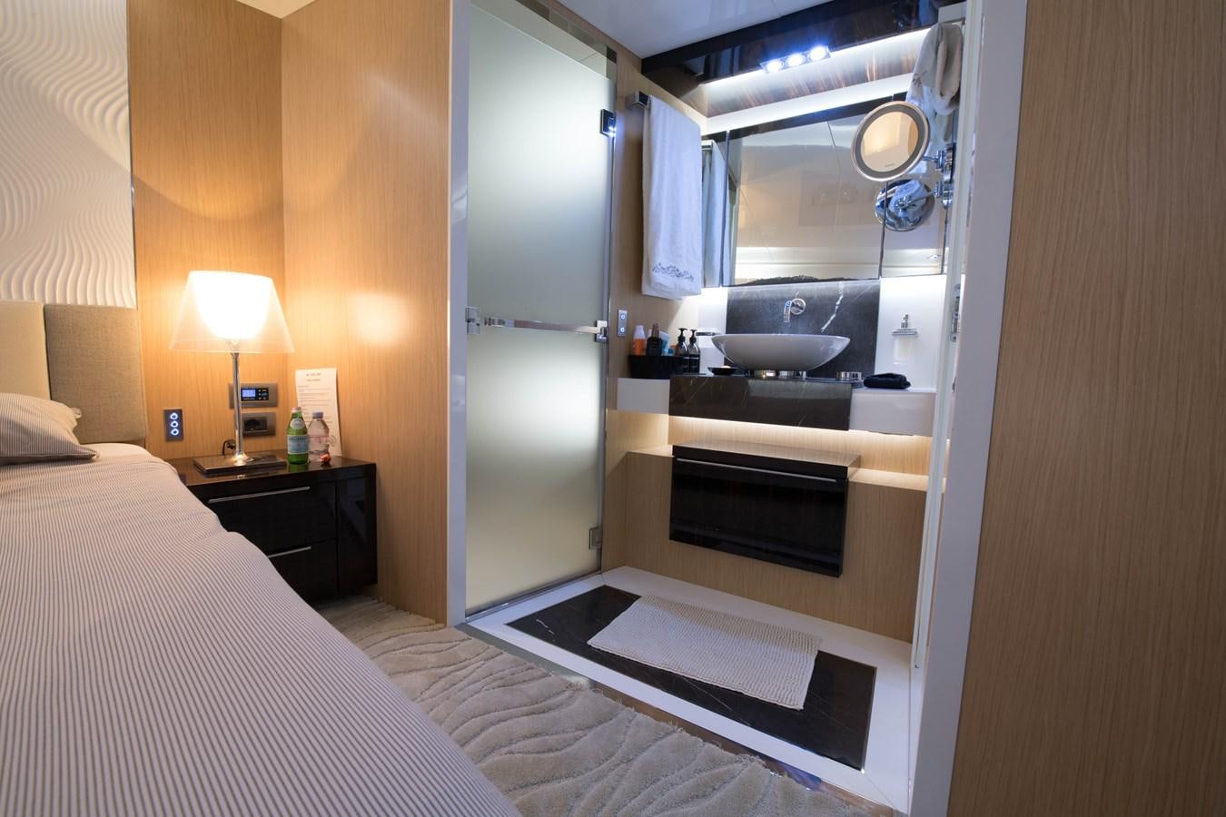 a hotel room with a bed and sink aboard NIGHT FURY Yacht for Sale