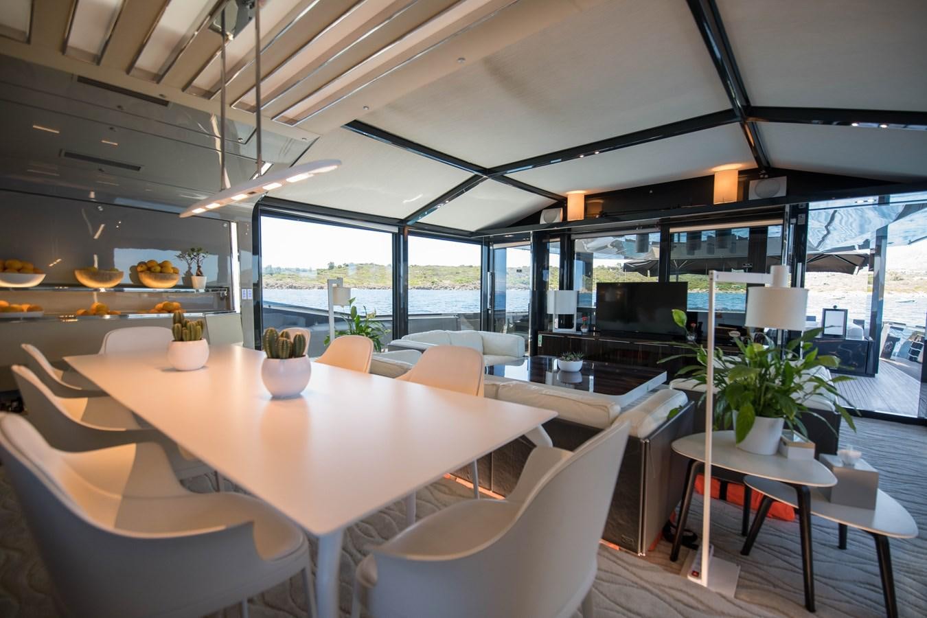 a room with tables and chairs aboard NIGHT FURY Yacht for Sale