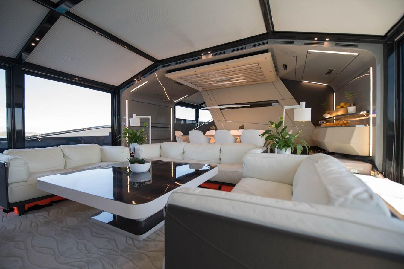 a living room with white couches aboard NIGHT FURY Yacht for Sale