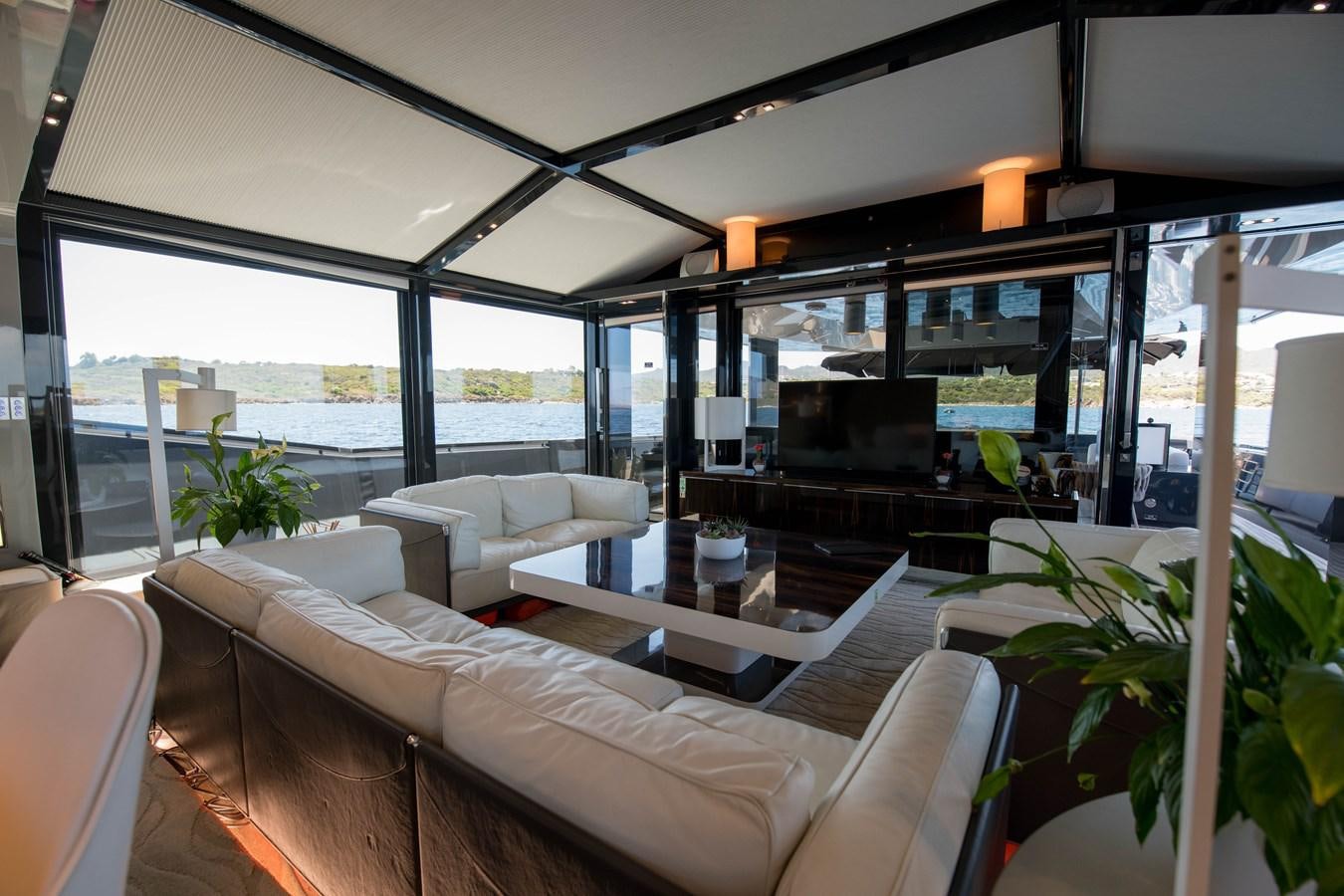 a living room with a large glass window aboard NIGHT FURY Yacht for Sale