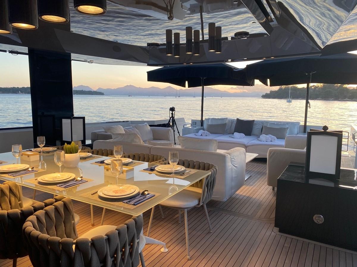 a room with a table and chairs aboard NIGHT FURY Yacht for Sale
