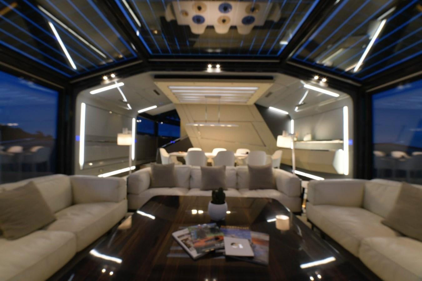 a room with couches and a table aboard NIGHT FURY Yacht for Sale