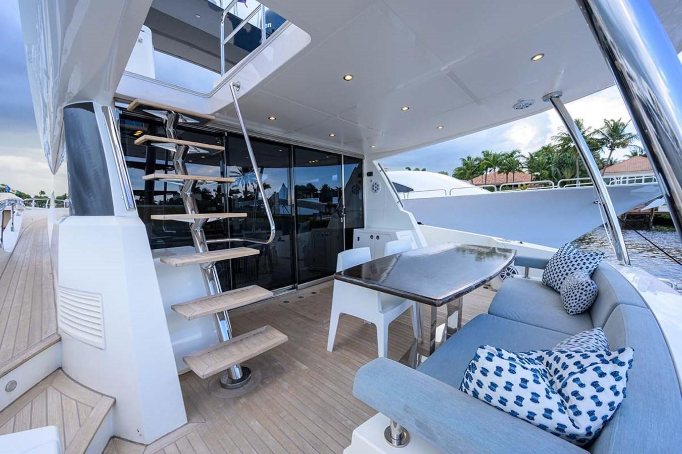 a room with a table and a couch aboard XHALE Yacht for Sale