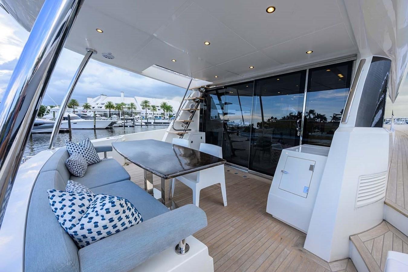 a room with a couch and a table and a large window aboard XHALE Yacht for Sale