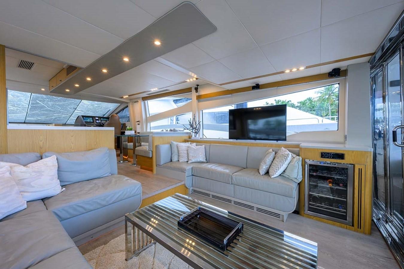 a living room with a couch and a tv aboard XHALE Yacht for Sale