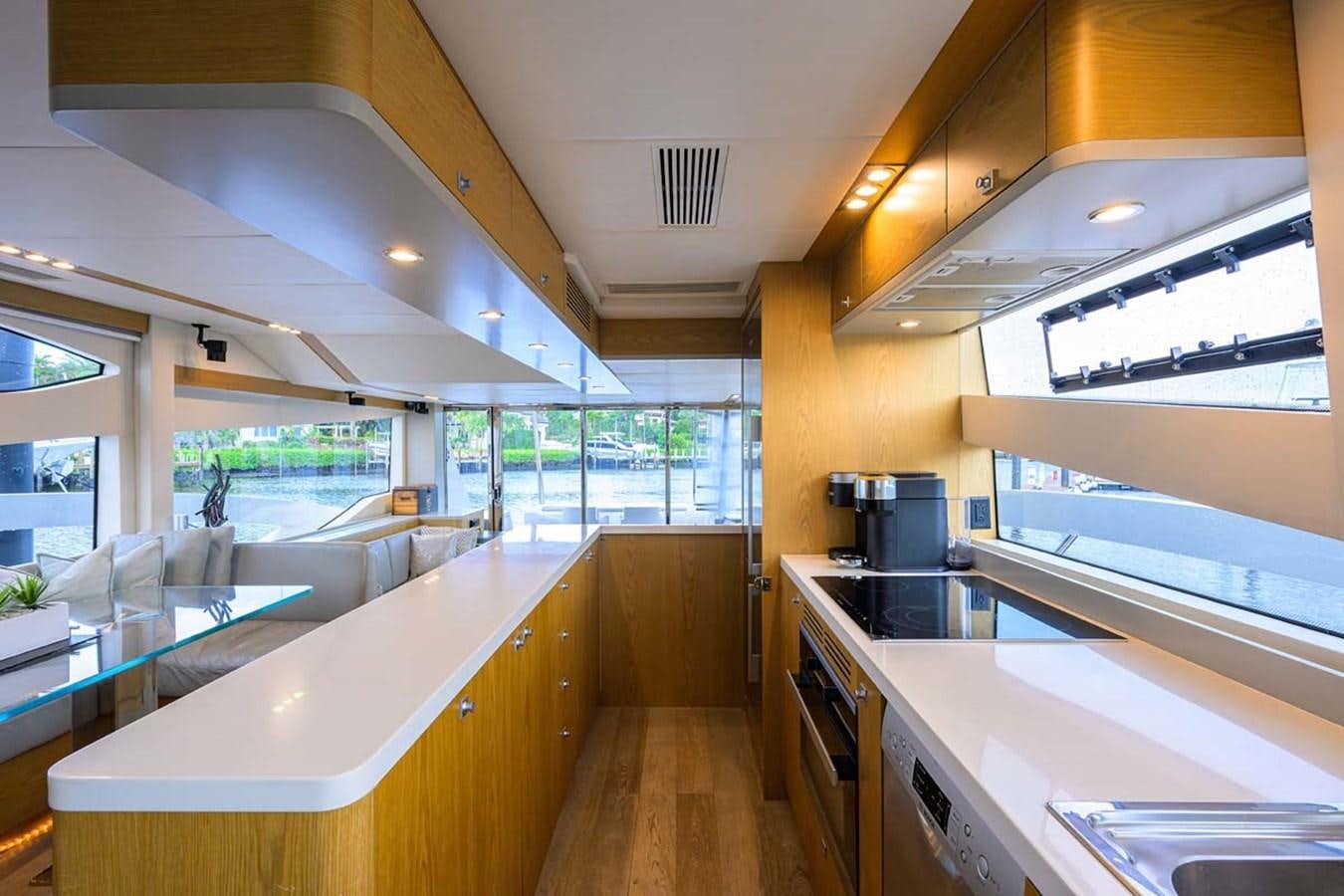 a kitchen with white cabinets aboard XHALE Yacht for Sale