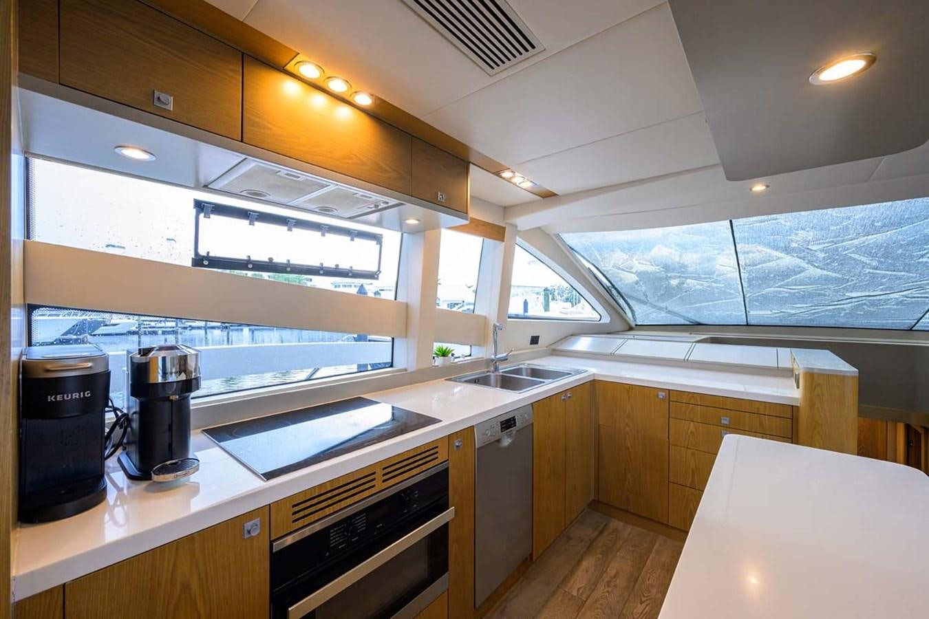 a kitchen with a large window aboard XHALE Yacht for Sale
