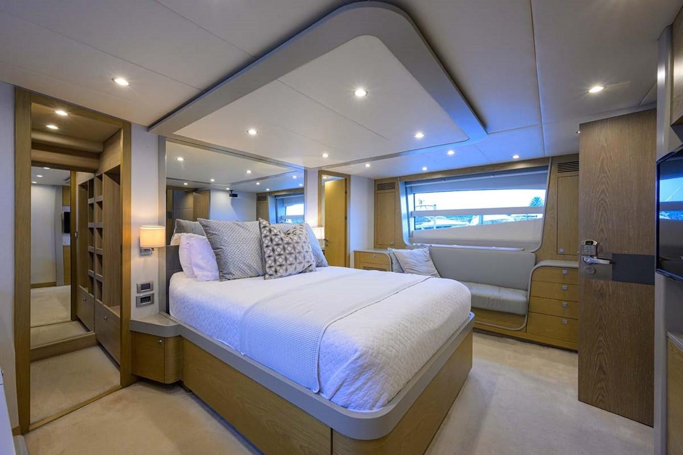 a room with a bed and a door aboard XHALE Yacht for Sale