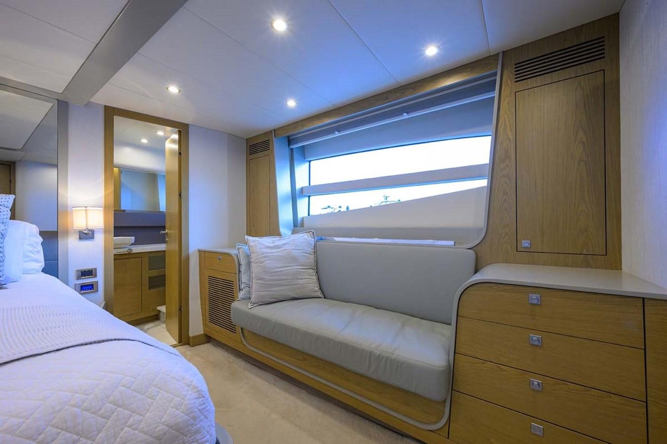 a room with a bed and a window aboard XHALE Yacht for Sale