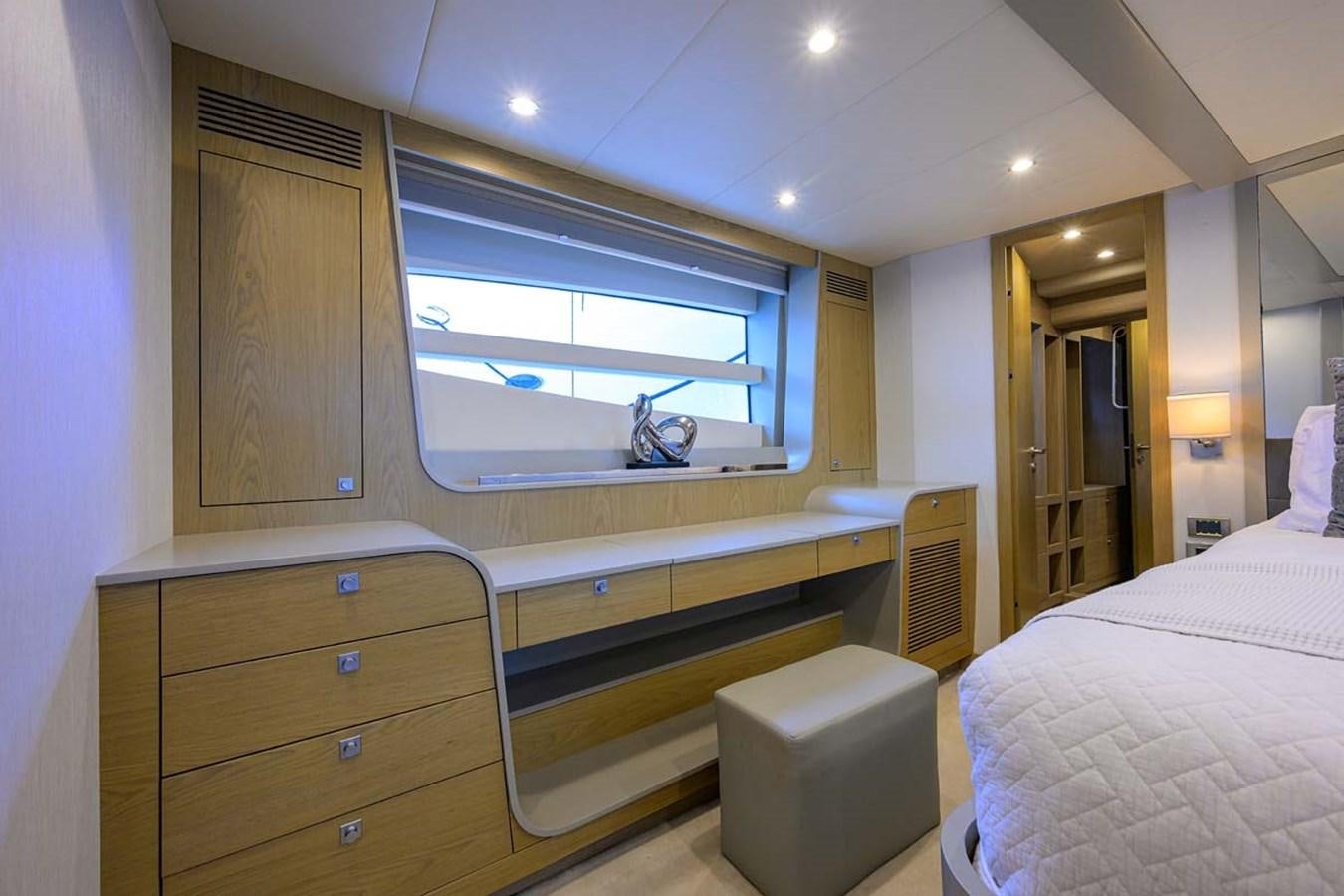 a bedroom with a bed and a window aboard XHALE Yacht for Sale