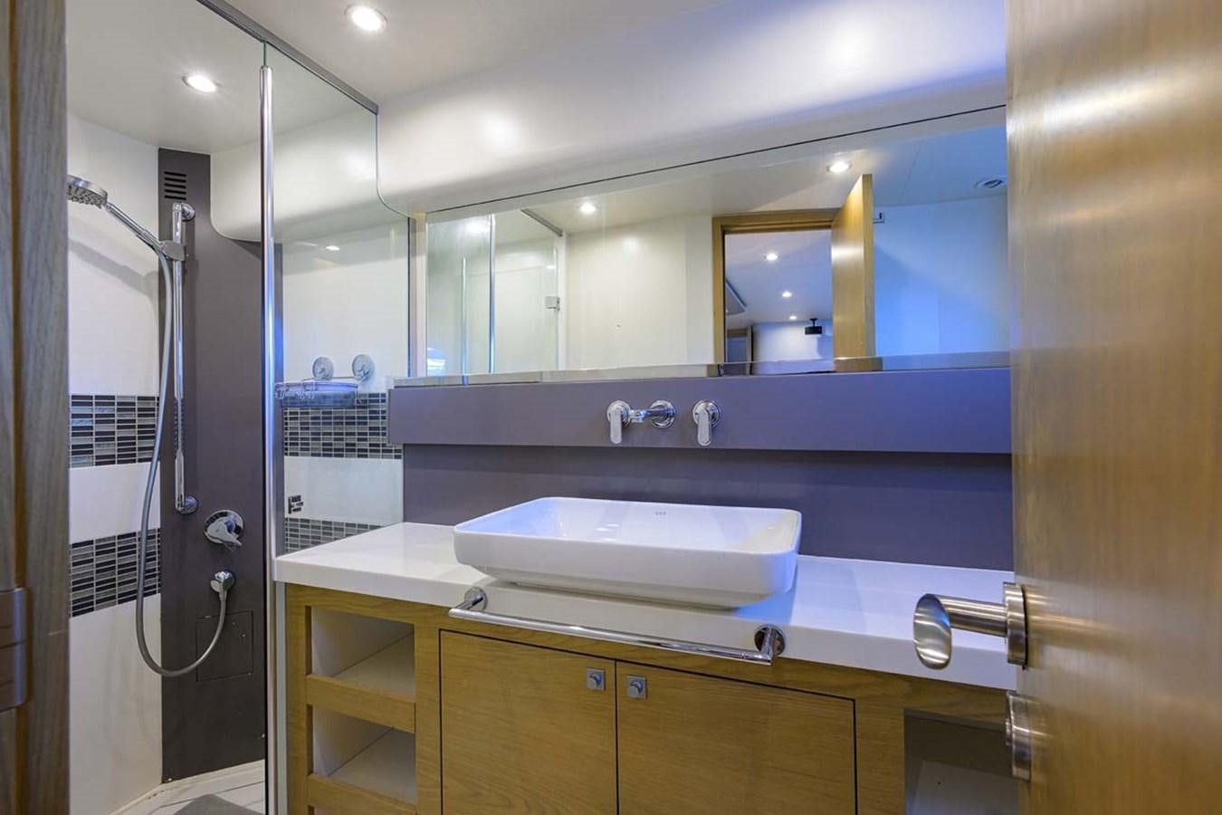 a bathroom with a sink and a mirror aboard XHALE Yacht for Sale