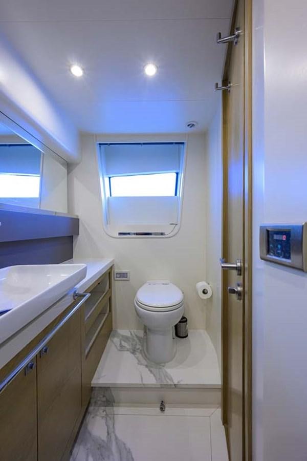 a bathroom with a toilet and a sink aboard XHALE Yacht for Sale