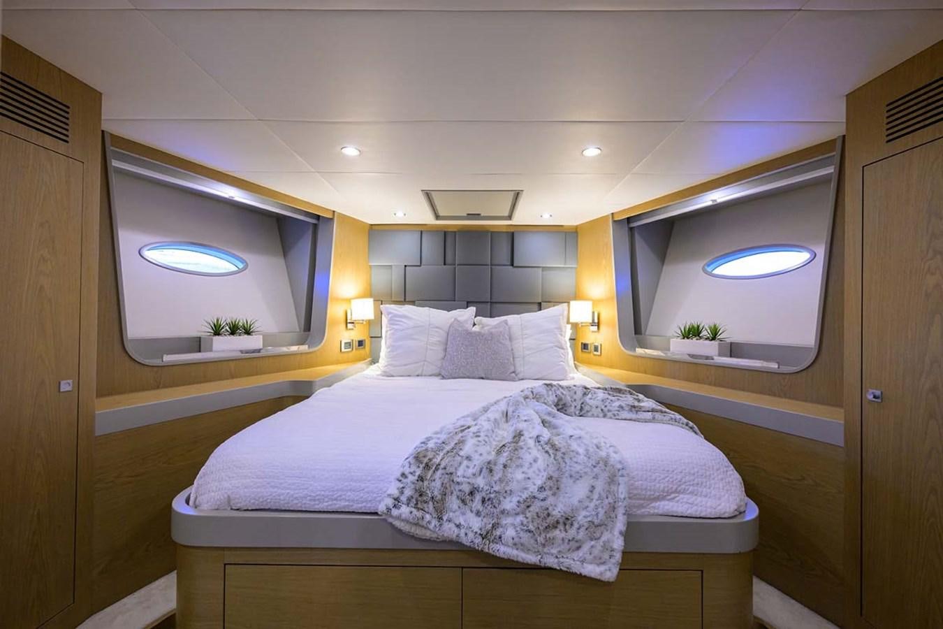 a bedroom with a large mirror aboard XHALE Yacht for Sale