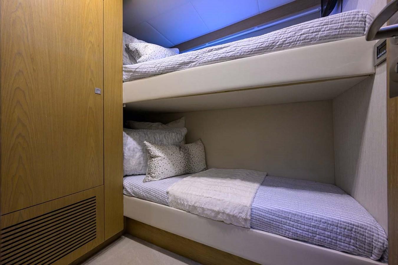 a bed with white sheets aboard XHALE Yacht for Sale