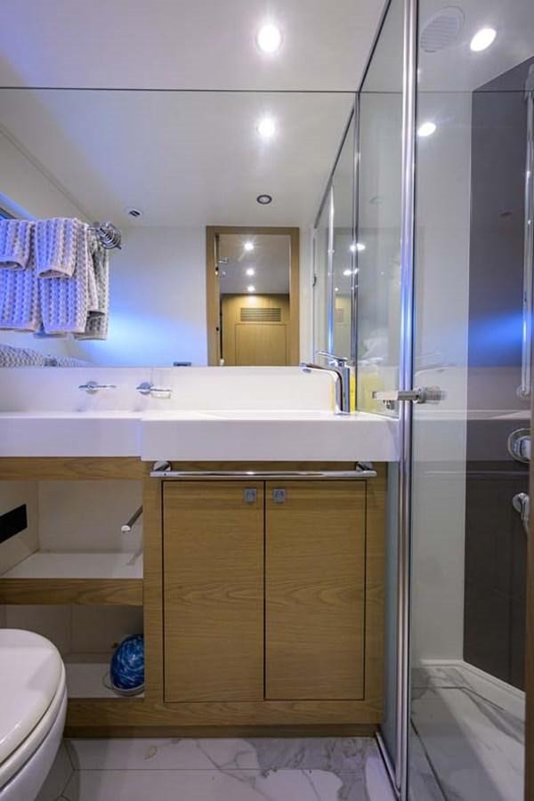 a bathroom with a standup shower aboard XHALE Yacht for Sale