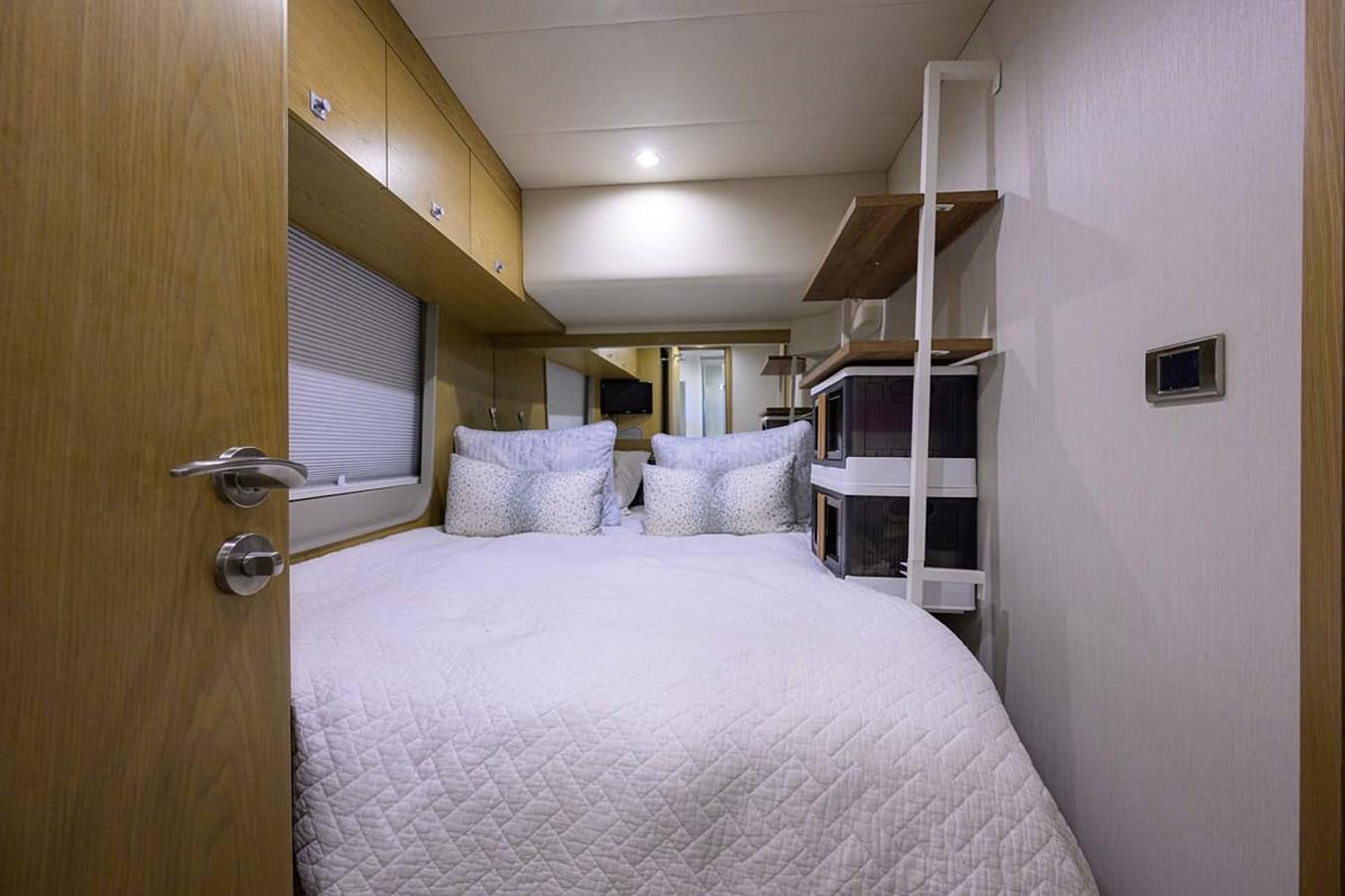 a bed with a white sheet aboard XHALE Yacht for Sale