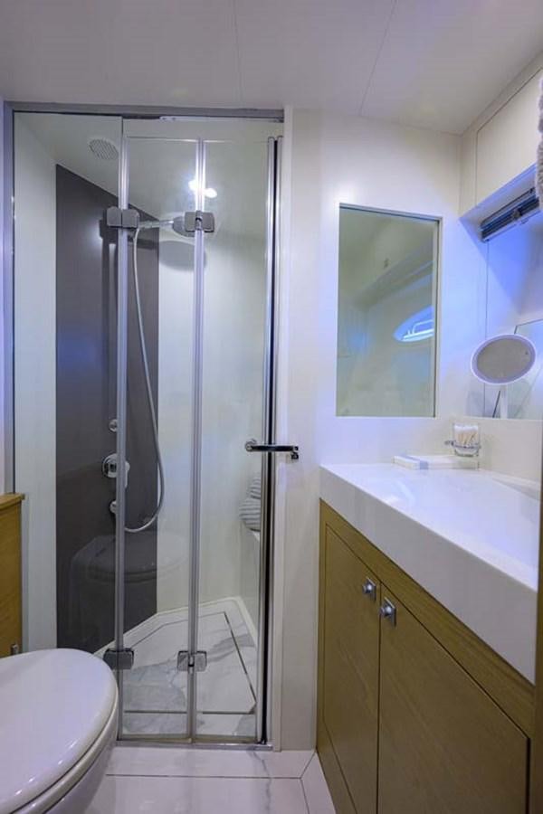 a bathroom with a glass shower aboard XHALE Yacht for Sale