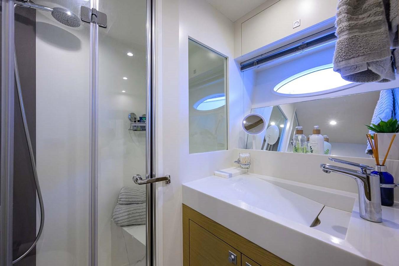 a bathroom with a glass shower aboard XHALE Yacht for Sale
