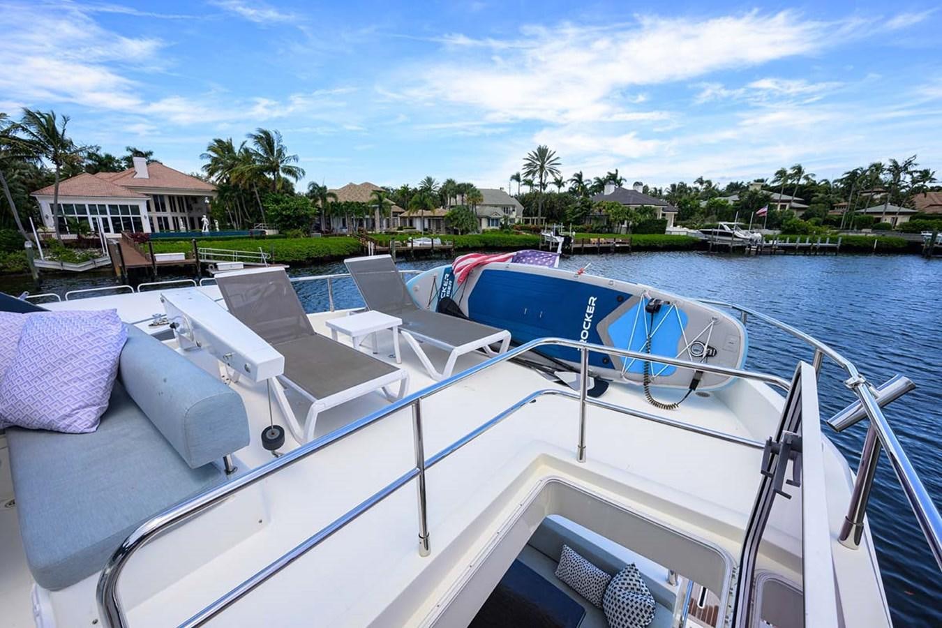 a boat with many seats on the deck aboard XHALE Yacht for Sale