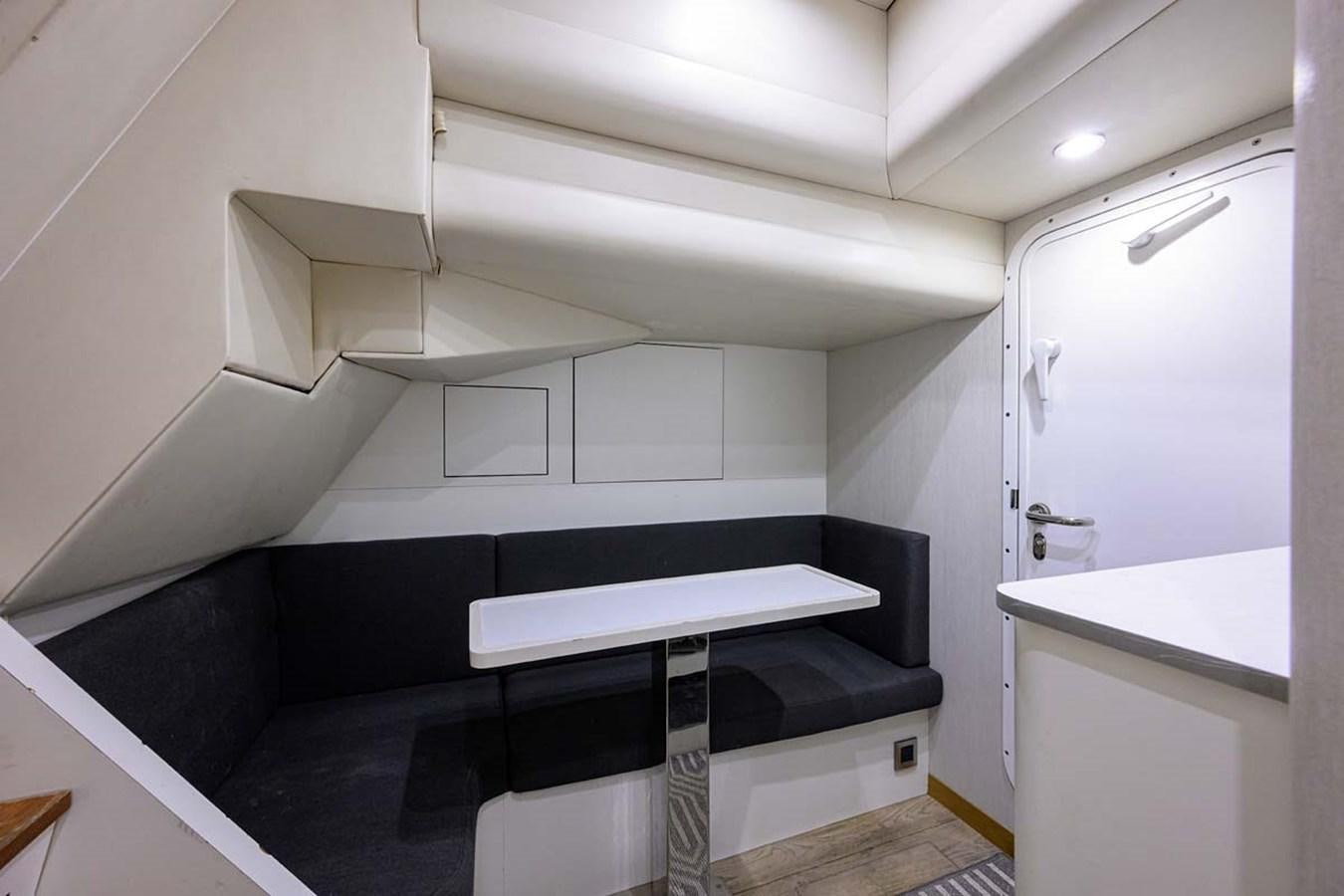 a room with a bed and a desk aboard XHALE Yacht for Sale