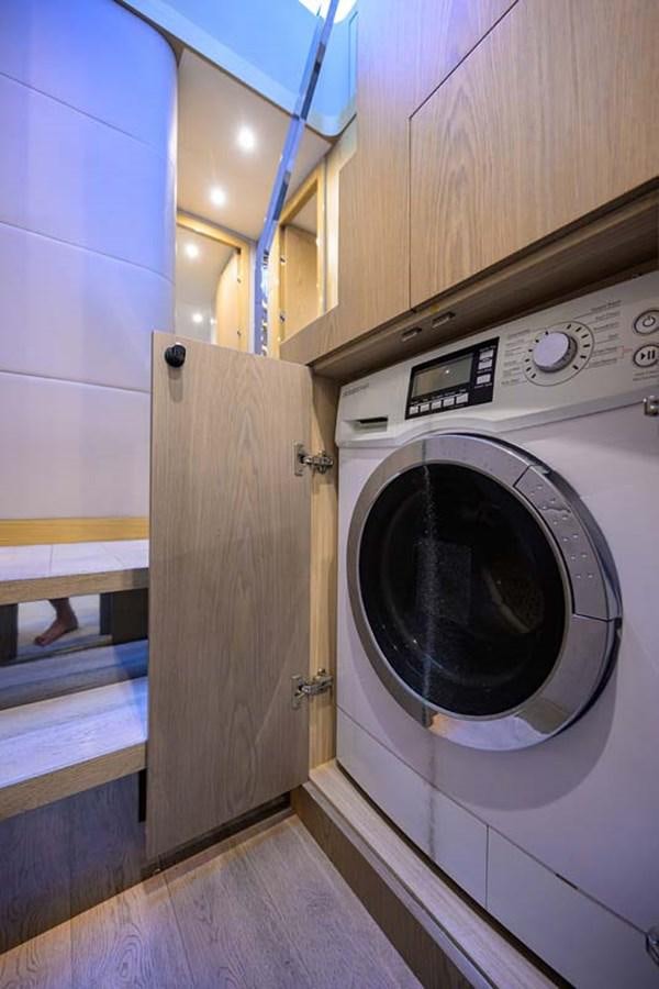 a washing machine in a room aboard XHALE Yacht for Sale