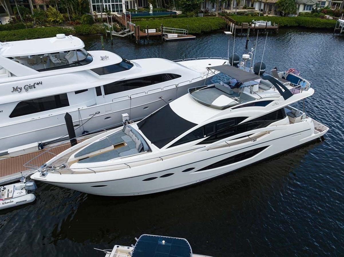 a white yacht docked at a dock aboard XHALE Yacht for Sale