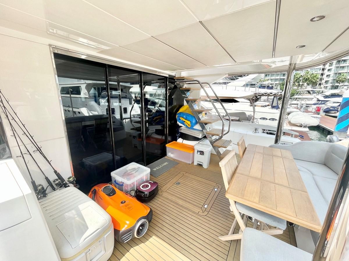 inside of a building with a large window and a table and chairs aboard EXCELLENCE Yacht for Sale