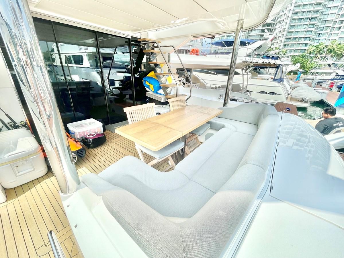 a room with a car and a ladder aboard EXCELLENCE Yacht for Sale