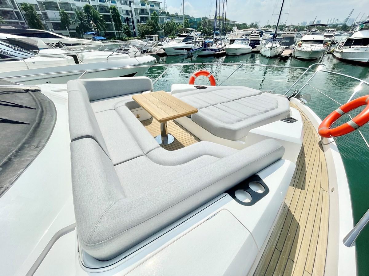 a boat with a chair on the deck aboard EXCELLENCE Yacht for Sale