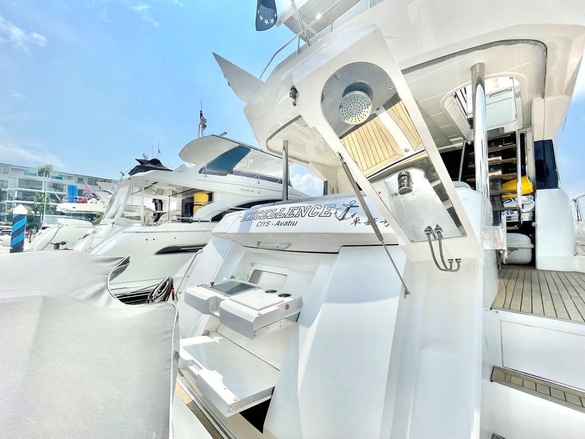 a white boat on a dock aboard EXCELLENCE Yacht for Sale