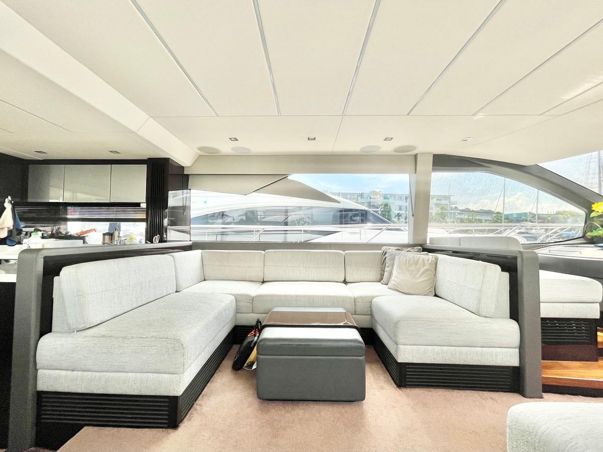 a room with couches and a large window aboard EXCELLENCE Yacht for Sale