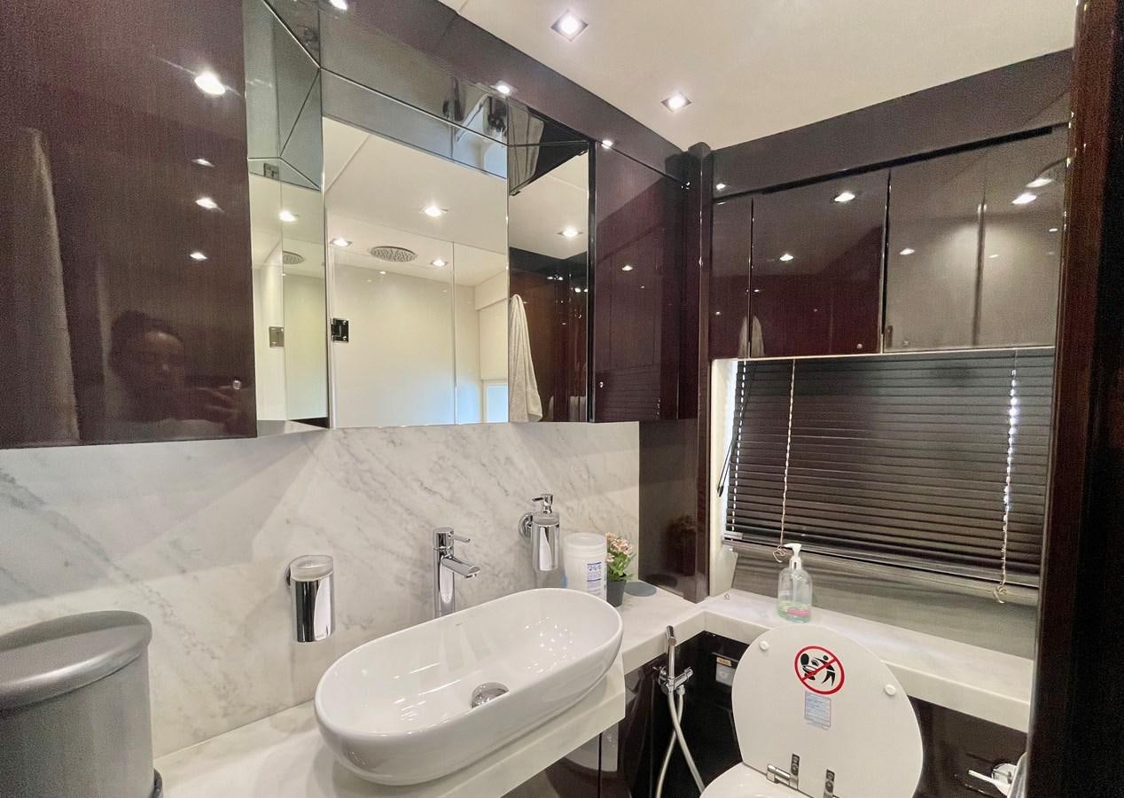 a bathroom with a large mirror aboard EXCELLENCE Yacht for Sale