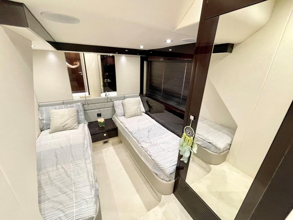 a room with a bed and a mirror aboard EXCELLENCE Yacht for Sale